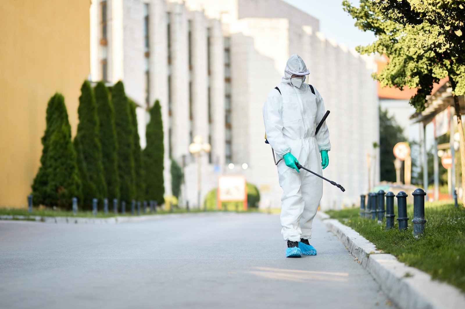 man-protective-suit-disinfecting-city-streets-coronavirus-pandemic