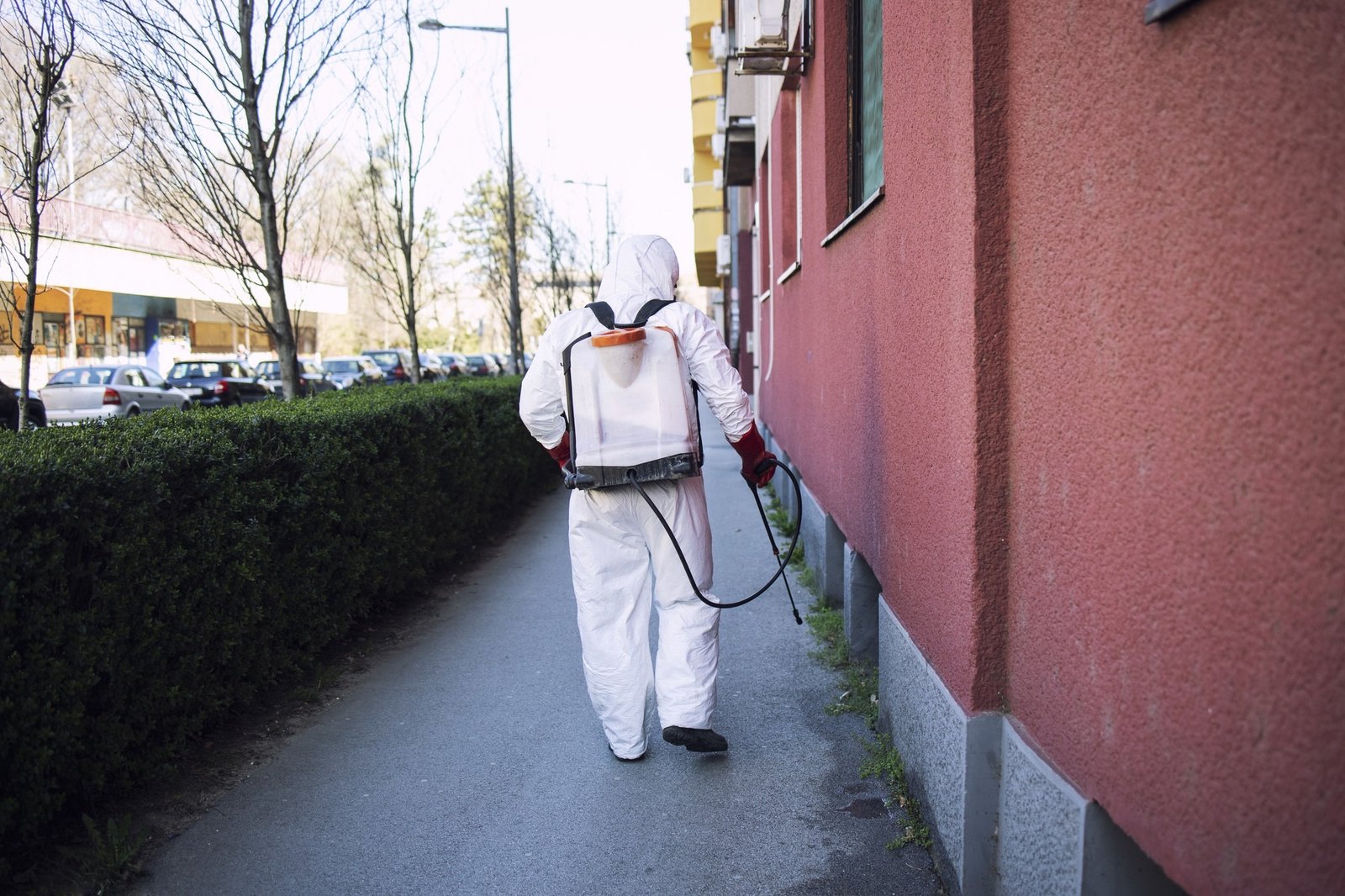 worker-chemical-protection-suit-spraying-disinfectant-public-surfaces